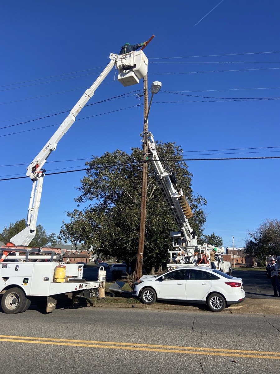 Crew members setting the new pole